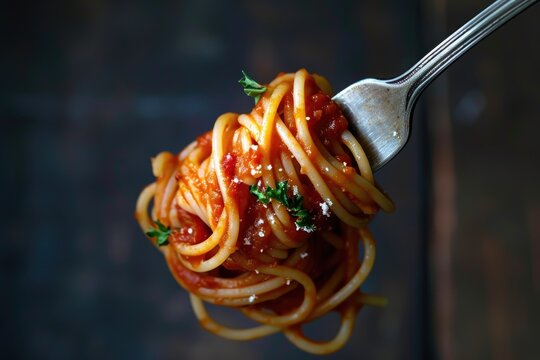 Zoomed in image of a fork with spaghetti and sauce