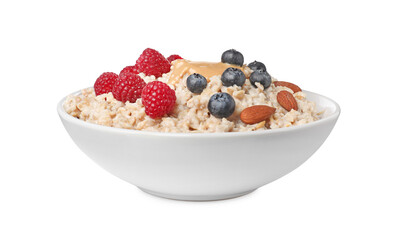 Tasty boiled oatmeal with berries, almonds and peanut butter in bowl isolated on white