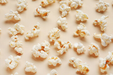 Tasty popcorn on beige background