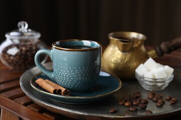 Obraz na płótnie Canvas Turkish coffee. Freshly brewed beverage served on wooden table, closeup
