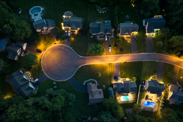 Residential illuminated homes at night in suburban sprawl development in Rochester, New York....