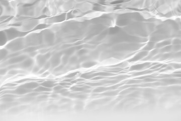 White water with ripples on the surface. Defocus blurred transparent white colored clear calm water surface texture with splashes and bubbles. Water waves with shining pattern texture background.