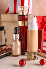 Christmas composition with makeup products on light background, closeup