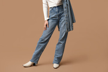 Naklejka premium Beautiful young Asian woman in stylish denim clothes on brown background, closeup