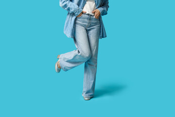 Fototapeta premium Beautiful young Asian woman in stylish denim clothes on blue background, closeup