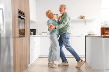 Mature couple dancing in kitchen