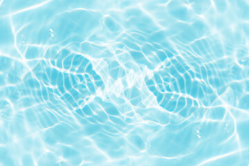 Bluewater waves on the surface ripples blurred. Defocus blurred transparent blue colored clear calm water surface texture with splash and bubbles. Water waves with shining pattern texture background.