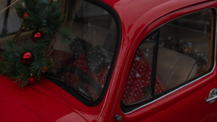 
A vibrant red scarab car adorned with Christmas decorations, filled to the brim with festive...