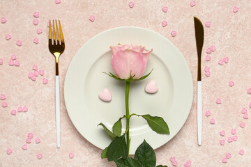 Beautiful table setting with pink rose and hearts on beige background. Valentine's Day celebration