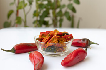 red chilli pickle in transparent glass bowl - marinated with Fenugreek Water and oil