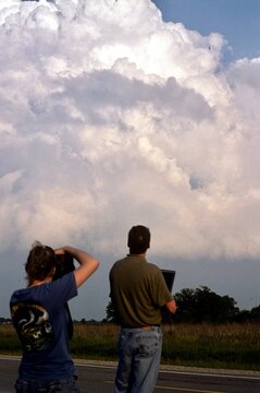 Storm chasers in the field viewing a pre-tornadic thunderstorm.