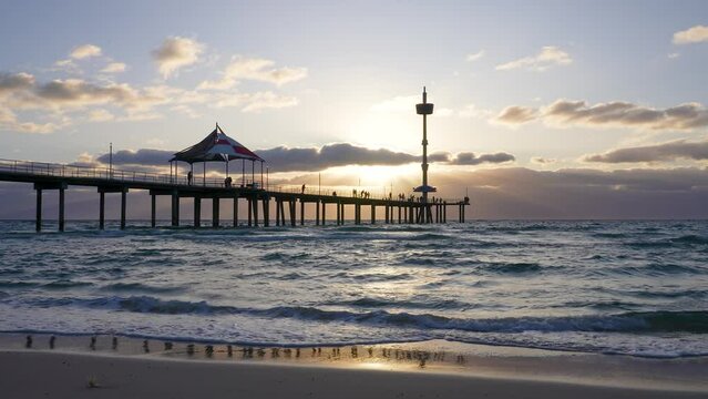 Brighton Beach jetty, waves and reflection at sunset, Adelaide, South Australia