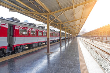 Passenger cars white red color of the train on the platform of the railway station.