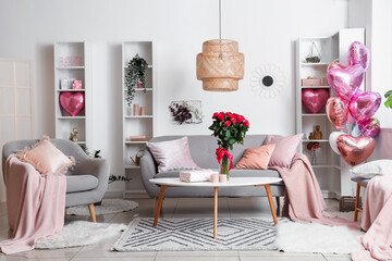 Interior of festive living room with heart-shaped balloons and bouquet of roses on table. Valentine's Day celebration