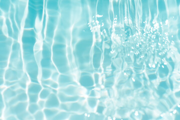 Bluewater waves on the surface ripples blurred. Defocus blurred transparent blue colored clear calm water surface texture with splash and bubbles. Water waves with shining pattern texture background. - obrazy, fototapety, plakaty