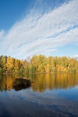 Fototapeta na wymiar Clouds and blue sky over the river with beautiful autumn colors