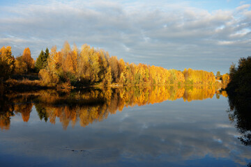 Dark clouds over the river with beautiful fall colors