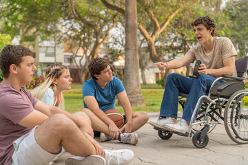 Disabled teen and friends looking at the mobile outdoors