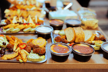 Different foods served on a tray at a Swedish Buffet Party. Many snacks on a table at a festive gathering 

