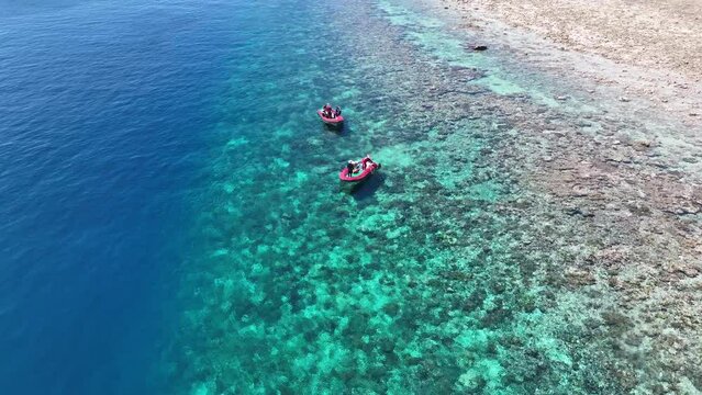 Clear water covers a beautiful reef surrounding the remote island of Koon near Seram, Indonesia. This scenic island's coral reefs, and the surrounding seas, support extraordinary marine biodiversity.