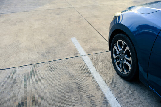 close up of modern car in parking lot, grunge surface of street, car parked in the right position in outdoor shopping plaza carpark area, shallow depth of field