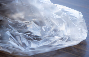 plastic bag on wooden background, closeup of plastic bag concept