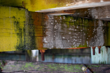 Old wooden pier, with rusty bolt. Closeup background with copy space.