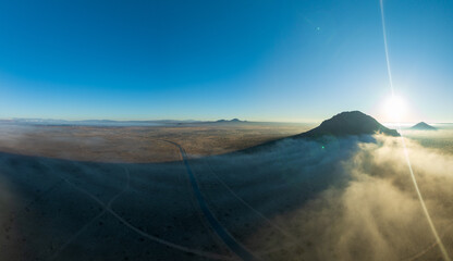 Aerial Capture of a Butte Shrouded in Evening Fog’s Gentle Embrace