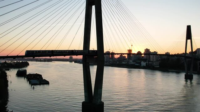 Aerial Footage During Sunset. Vancouver, British Columbia, Canada. Aerial View of The SkyBridge is a Cable-Stayed Bridge for Sky Trains between New Westminster and Surrey. 