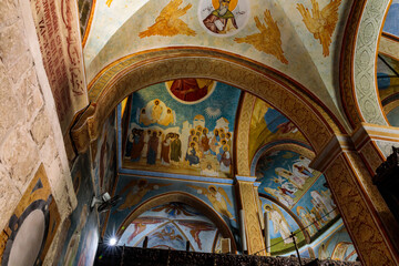 Fototapeta na wymiar Walls painted on a religious theme in main hall of the Greek Orthodox Church of the Annunciation in Nazareth old city in northern Israel