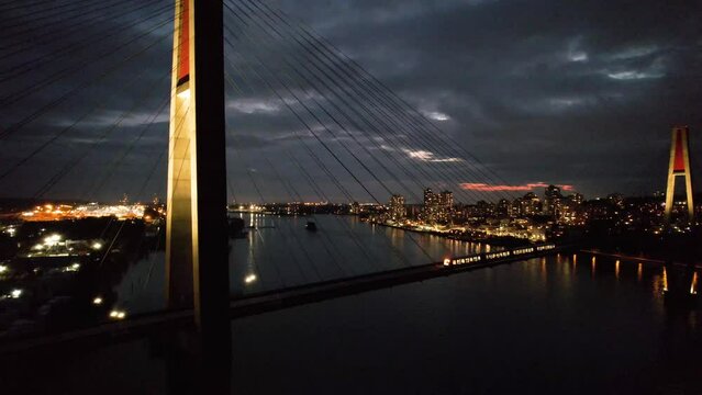 Aerial Footage During the Night. Vancouver, British Columbia, Canada. Aerial View of The SkyBridge is a Cable-Stayed Bridge for Sky Trains between New Westminster and Surrey.