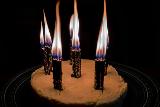 Spooky Black Glittery Evil Witchy Birthday Candles in Birthday Cake with Black Background