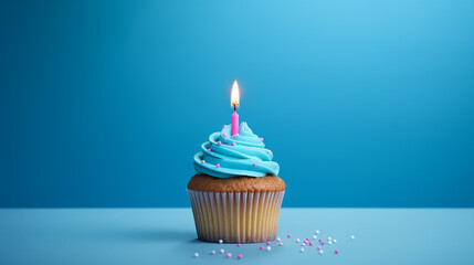 birthday cupcake with one candle on blue background and sprinkles - obrazy, fototapety, plakaty