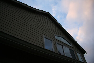 Back of home; upper windows and roof; pretty sunset