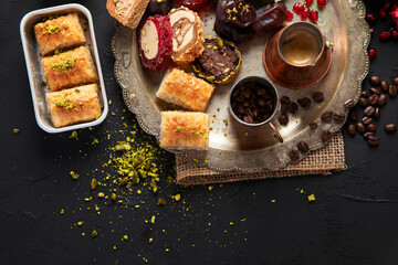 Hot tasty coffee with various pieces of turkish delight desets on a dark background. Traditional arabian food