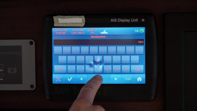 Ship captain enters Red Sea as destination into ship's AIS system. Close up