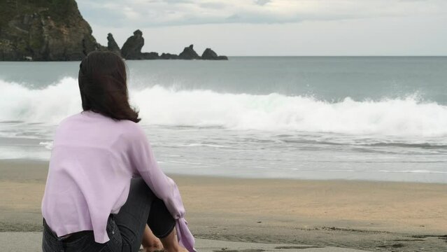 Lonely Soul Contemplates Roaring Waves. Woman Missing Loved One. Slow Motion