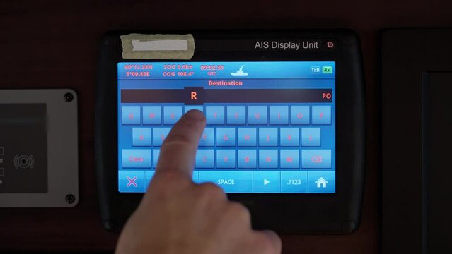 Captain entering Port Said as destination into ship's AIS navigation system