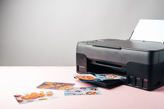 Modern laser printer printing color photos of food close up