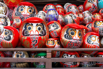 Traditional Japanese daruma dolls piled up at Shorinzan Daruma-ji Temple in Gunma Prefecture in Japan