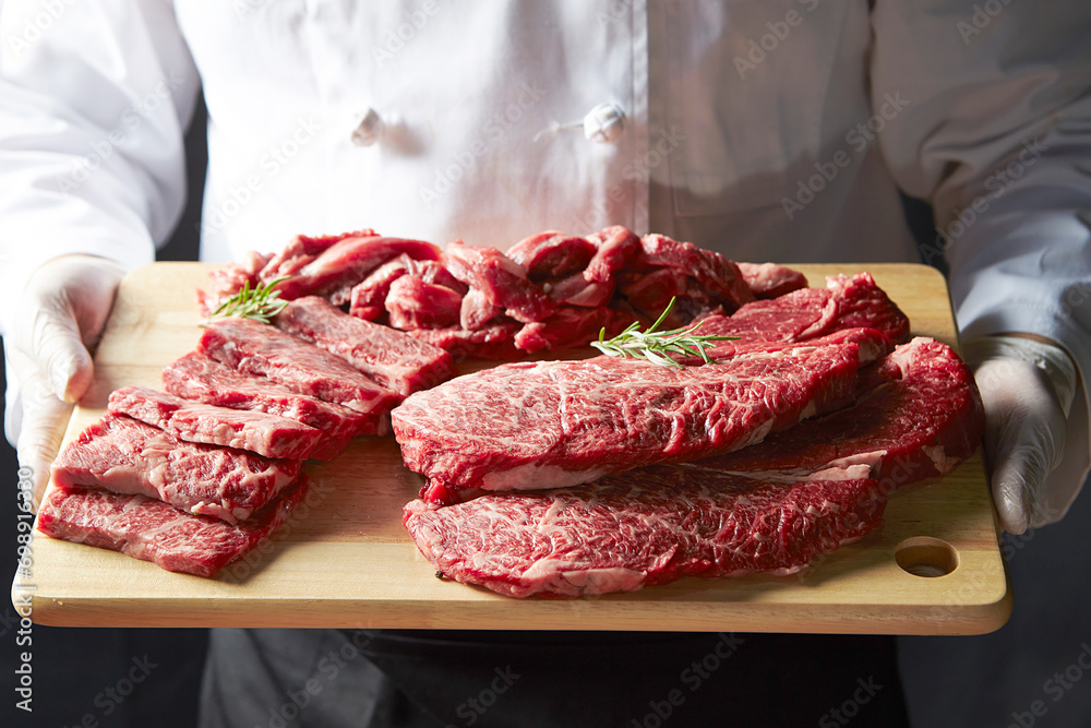 Wall mural several pieces of raw meat on a cutting board