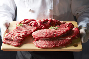 Several pieces of raw meat on a cutting board