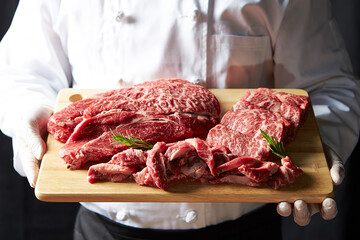 Several pieces of raw meat on a cutting board