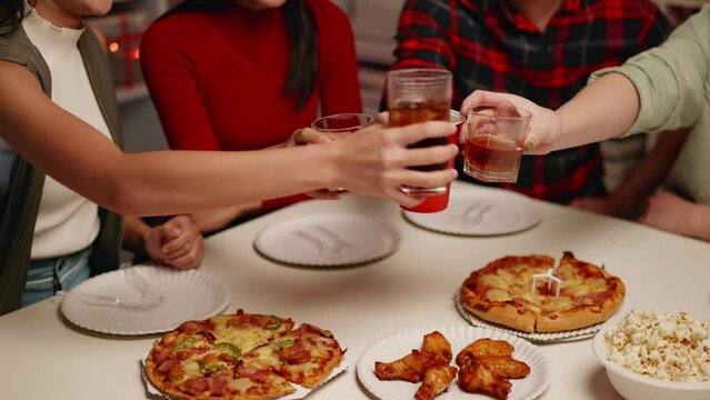 Friends join and celebrate the party with get cheers give a toast by clink glasses eating foods and drinks. Happy and joyful in holiday weekend and festival.