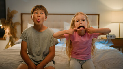 Funny happy Caucasian children kids boy girl brother sister siblings son daughter friends teasing...