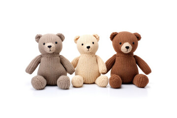Knitted brown and polar bears on white background with space for text. Knitted toys