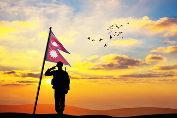 Silhouette of a soldier with the Nepal flag stands against the background of a sunset or sunrise. Concept of national holidays. Commemoration Day. - obrazy, fototapety, plakaty