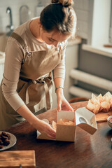 female bakery owner packs boxes for customer's order in birthday, Birthday package. small business...
