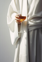 Woman with a glass of wine in white dress.