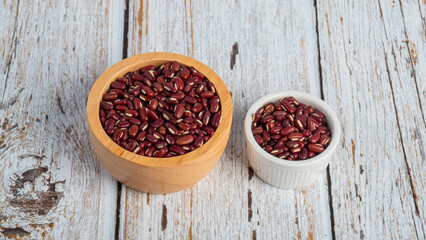Red kidney beans in white cup on wood background